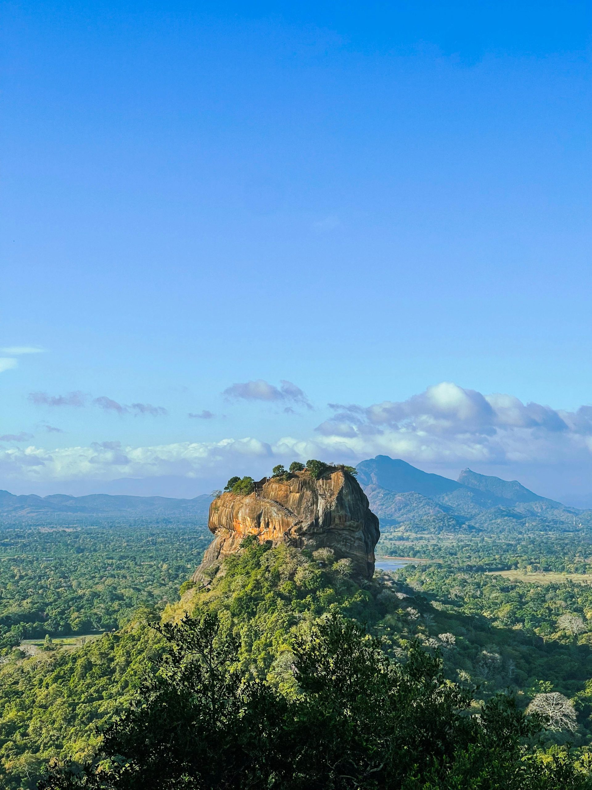 Breathtaking view of Sigiriya, the iconic rock fortress in Sri Lanka, set amidst lush green forests.